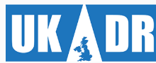 White lettering on a blue background reading UKADR. The 'A' is a white cut out with an outline of the UK in blue. United Kingdom Alliance for Disaster Research (UKADR) logo.